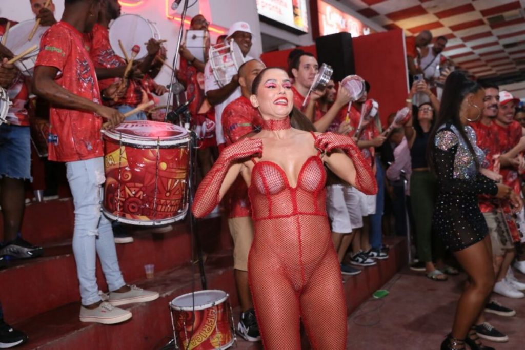 Deborah Secco de macacão de tela vermelha na quadra do Salgueiro